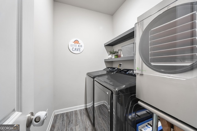 laundry area featuring hardwood / wood-style floors and washer and clothes dryer