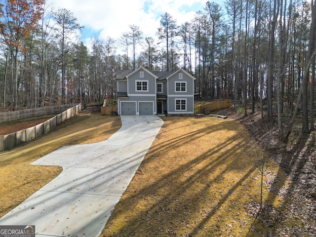 view of front of property featuring a front yard and a garage