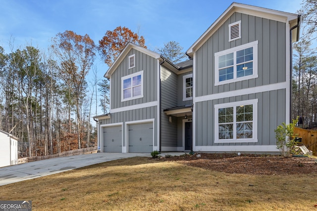 view of front of property with a front lawn and a garage