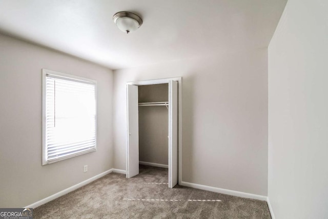 unfurnished bedroom with a closet and carpet