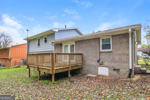 rear view of property featuring a wooden deck