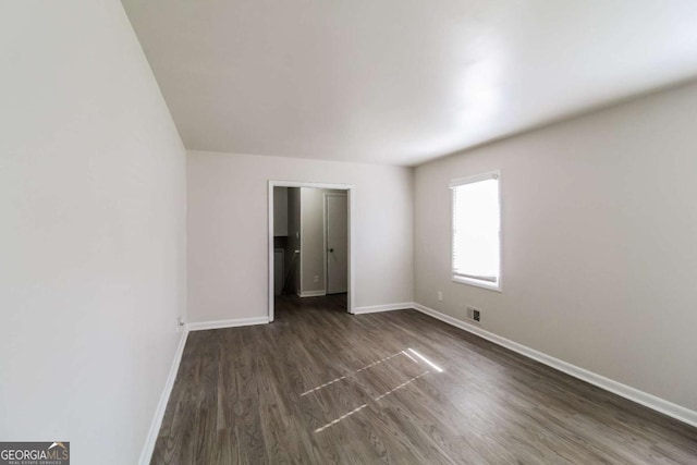 unfurnished bedroom with dark hardwood / wood-style floors