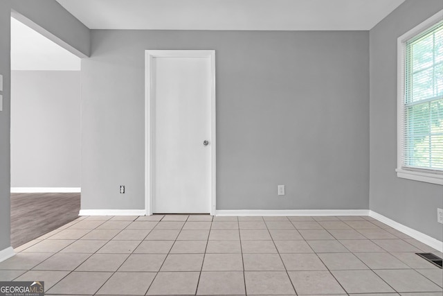 bathroom with tile patterned flooring, vanity, toilet, and a healthy amount of sunlight