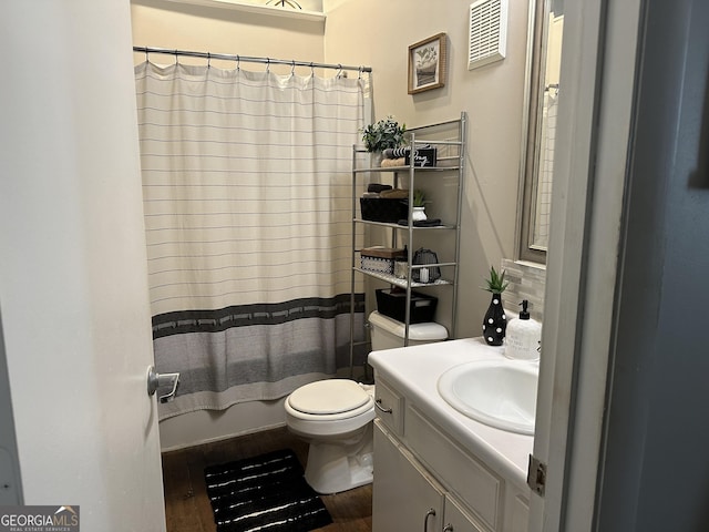 full bathroom with wood-type flooring, vanity, toilet, and shower / bath combo with shower curtain