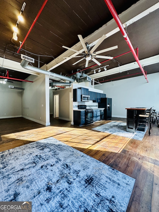 living room featuring ceiling fan and wood-type flooring