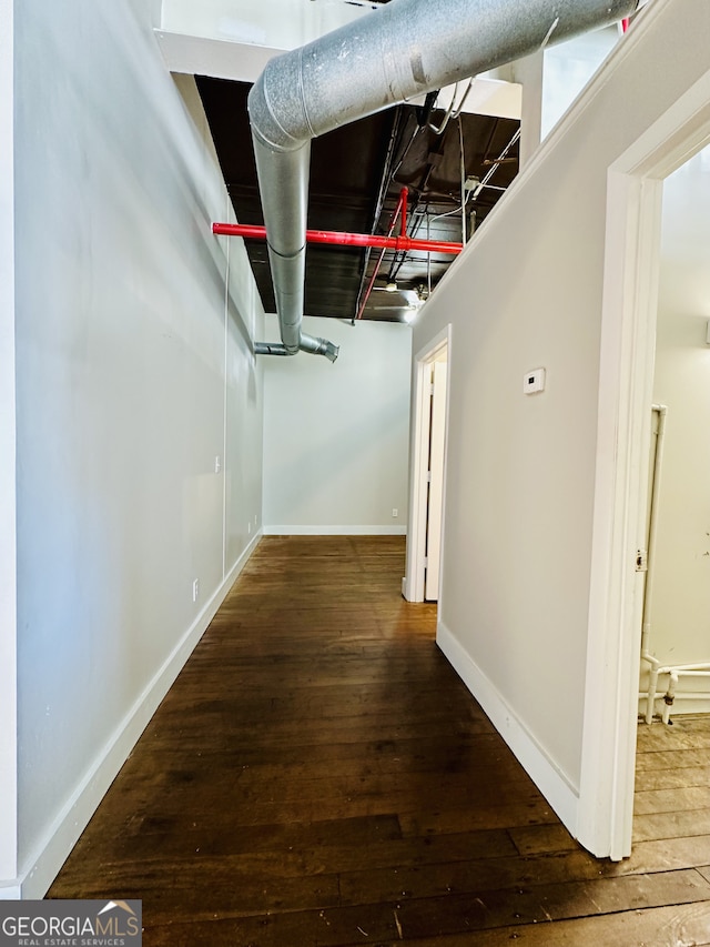 corridor with dark hardwood / wood-style flooring