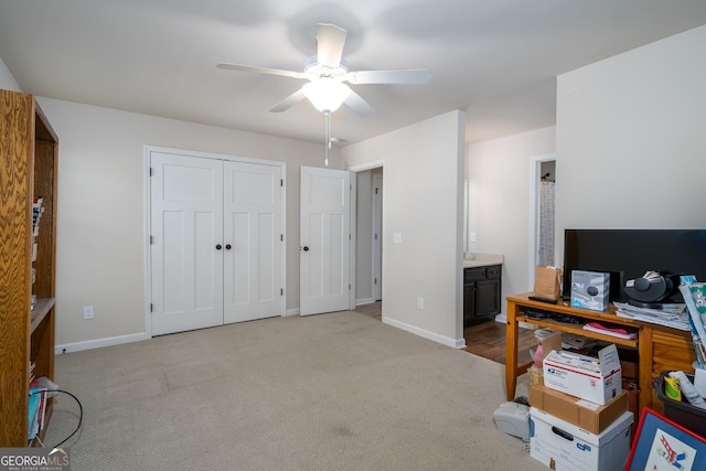 home office featuring ceiling fan and light colored carpet