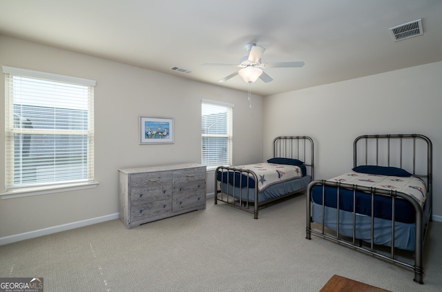 bedroom with ceiling fan and light colored carpet