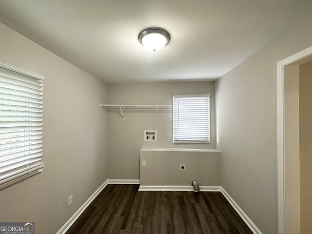 clothes washing area with hookup for an electric dryer, washer hookup, and dark wood-type flooring