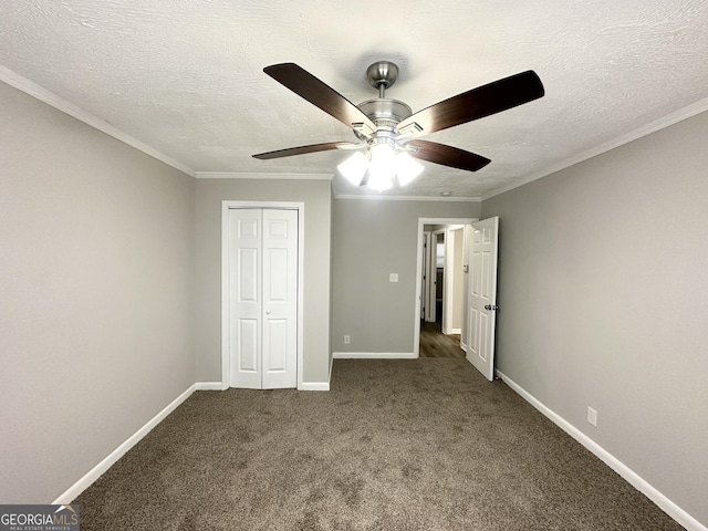 unfurnished bedroom with a textured ceiling, a closet, dark carpet, and ceiling fan