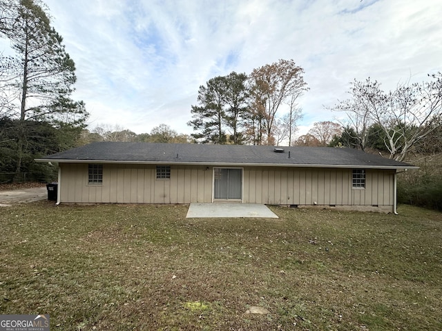 rear view of property featuring a yard and a patio