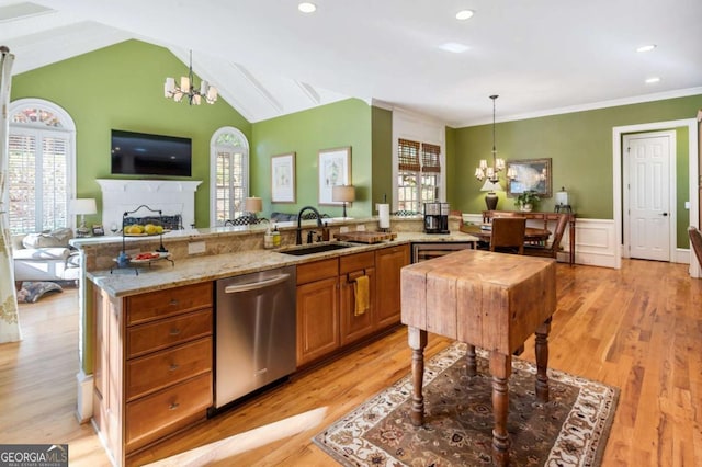 kitchen with stainless steel dishwasher, a notable chandelier, plenty of natural light, and sink