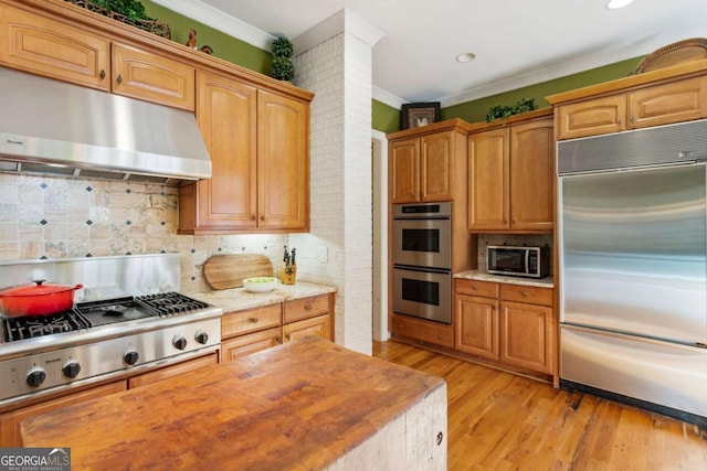 kitchen with decorative backsplash, ventilation hood, stainless steel appliances, crown molding, and light hardwood / wood-style flooring