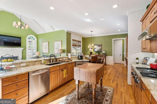 kitchen featuring hanging light fixtures, sink, light hardwood / wood-style flooring, appliances with stainless steel finishes, and a notable chandelier