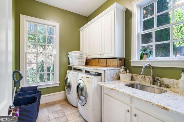 laundry room with separate washer and dryer, plenty of natural light, and sink