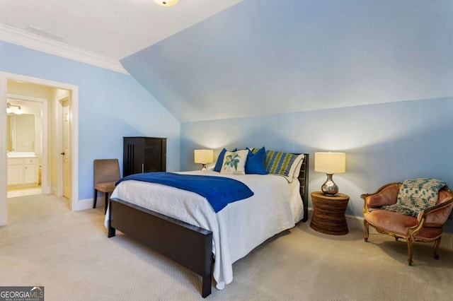 carpeted bedroom featuring ensuite bathroom, lofted ceiling, and ornamental molding