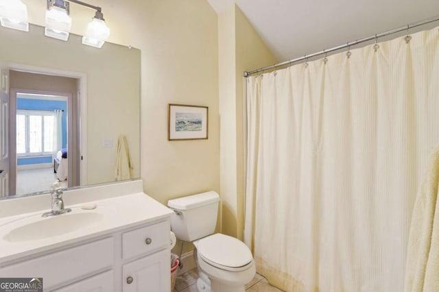 bathroom featuring tile patterned flooring, vanity, and toilet