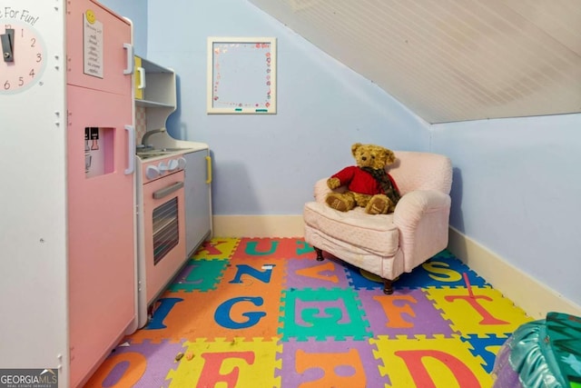 playroom featuring vaulted ceiling