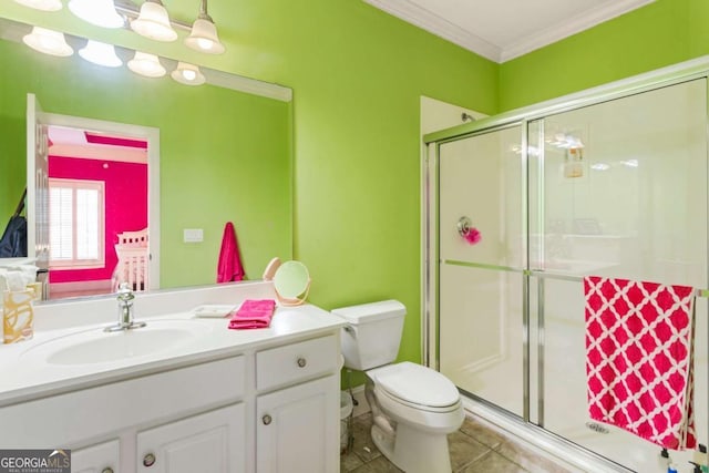 bathroom featuring tile patterned floors, vanity, a shower with door, crown molding, and toilet