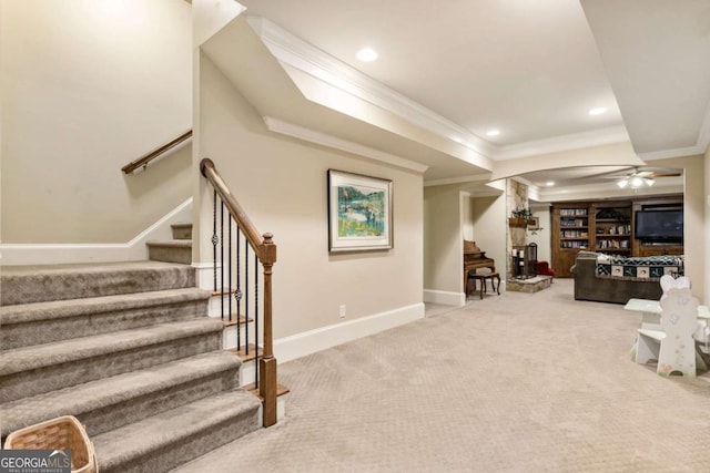 carpeted living room featuring ceiling fan and crown molding