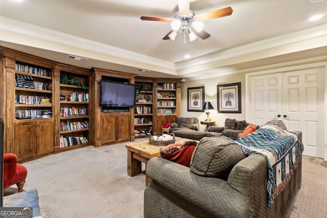 living room featuring ceiling fan, light colored carpet, and crown molding