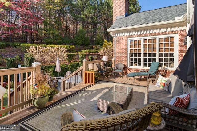 view of patio with outdoor lounge area and a deck