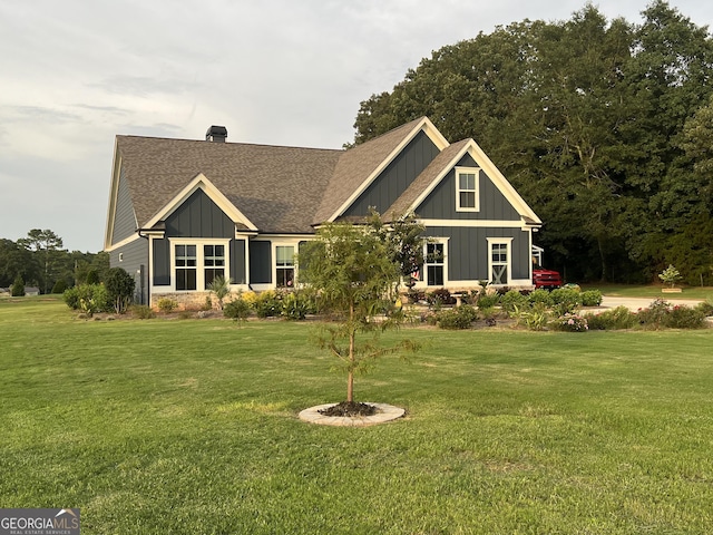 back of house featuring a lawn