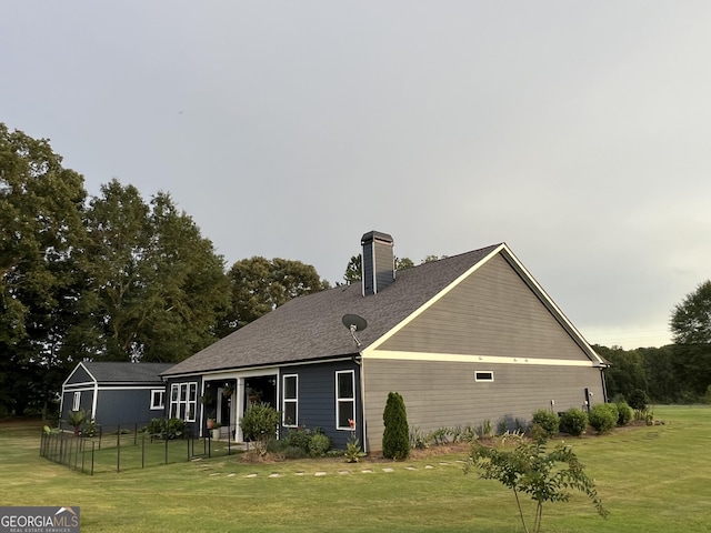 rear view of house featuring a yard