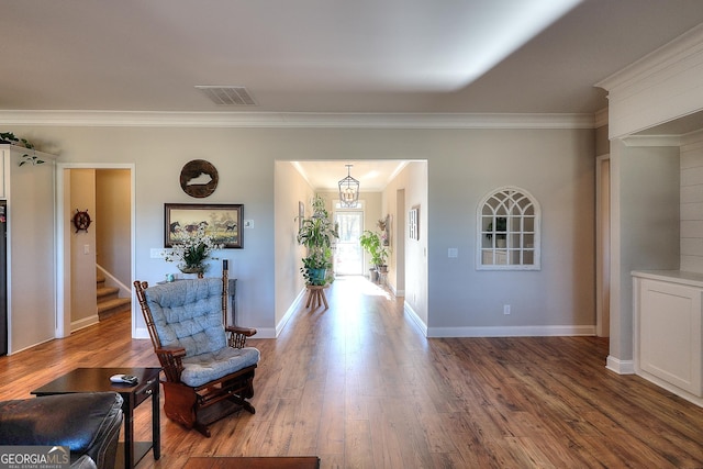 foyer featuring dark wood-type flooring and ornamental molding