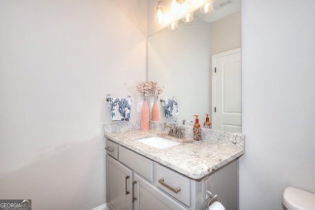 bathroom with toilet and vanity