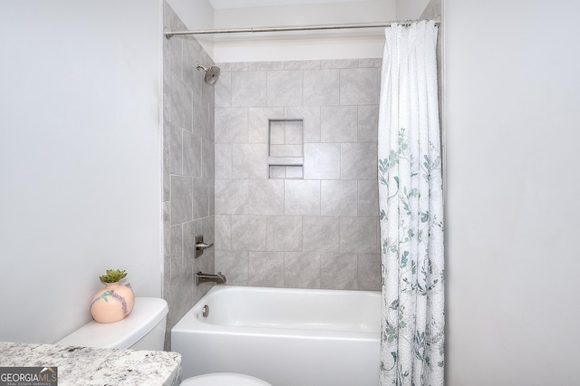 bathroom with toilet and shower / bath combo