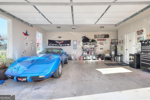 garage featuring electric water heater and a garage door opener