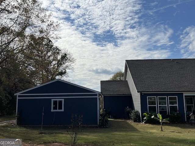 view of side of property with a yard