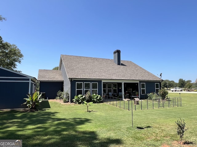 back of house with a lawn