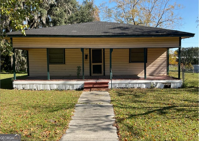 view of front of home with covered porch and a front yard