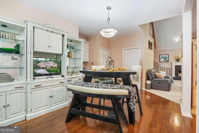 dining room featuring a fireplace and dark hardwood / wood-style floors