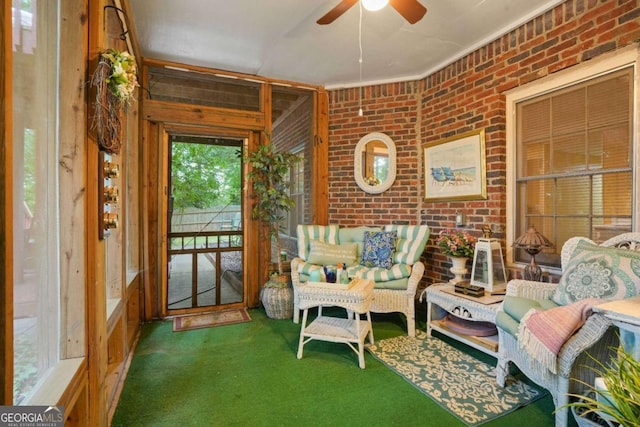 sunroom / solarium featuring ceiling fan