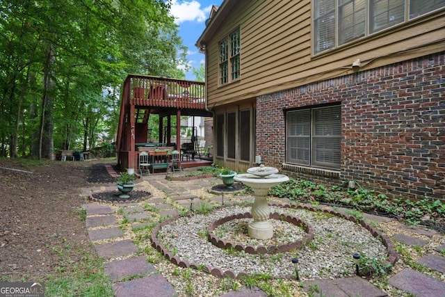 view of yard featuring a wooden deck and a patio area