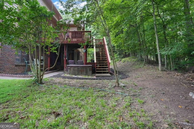 view of yard with central AC, a hot tub, and a deck