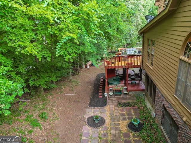 view of yard featuring a patio area and a deck