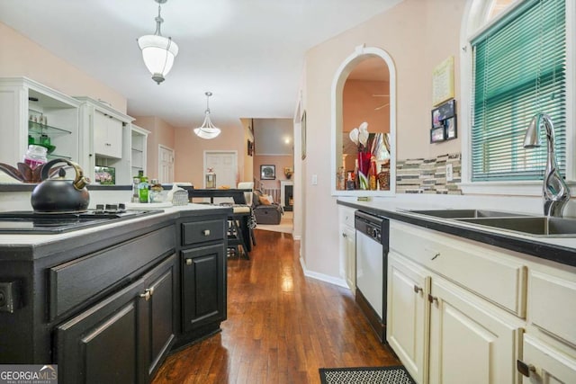 kitchen featuring dark hardwood / wood-style floors, hanging light fixtures, sink, and appliances with stainless steel finishes