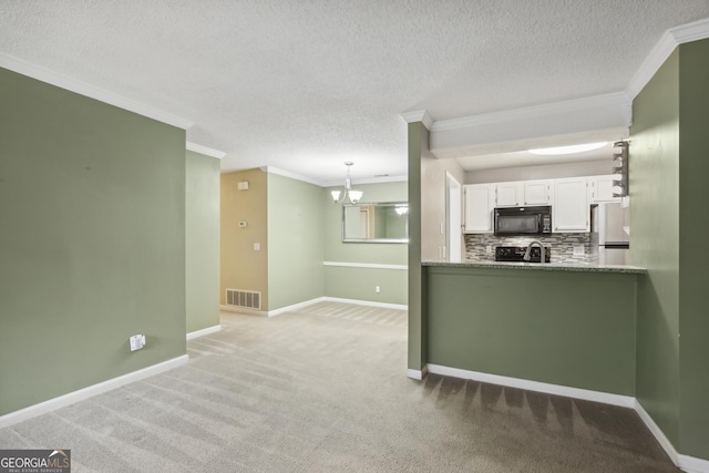 kitchen featuring backsplash, black appliances, pendant lighting, white cabinets, and carpet floors