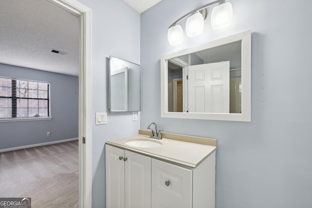 bathroom featuring vanity and a textured ceiling