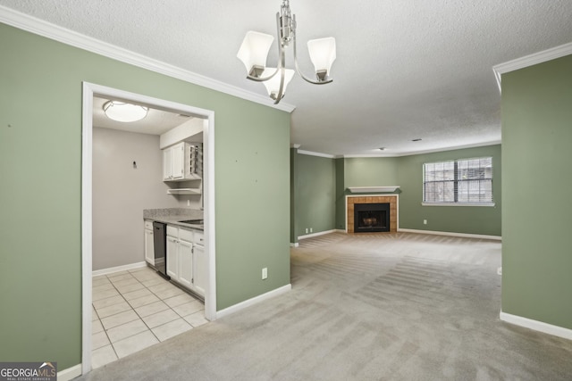 kitchen with light carpet, crown molding, dishwasher, a fireplace, and white cabinetry