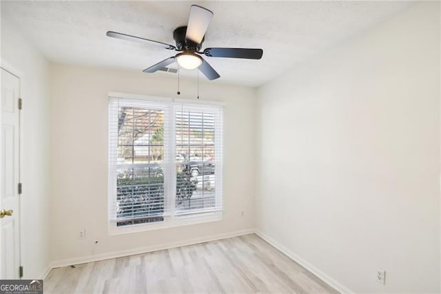 spare room featuring light hardwood / wood-style flooring and ceiling fan