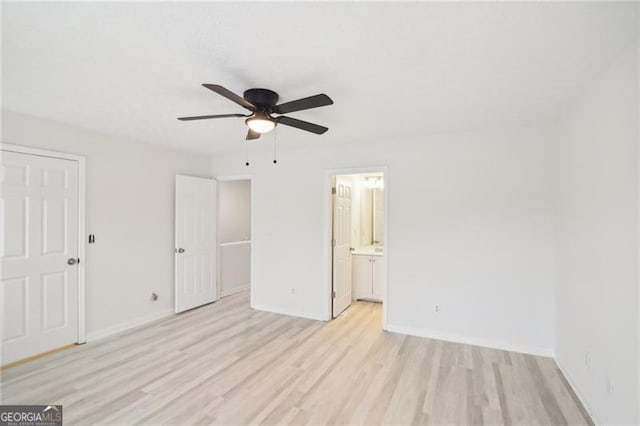 unfurnished bedroom with ceiling fan, ensuite bathroom, and light hardwood / wood-style flooring