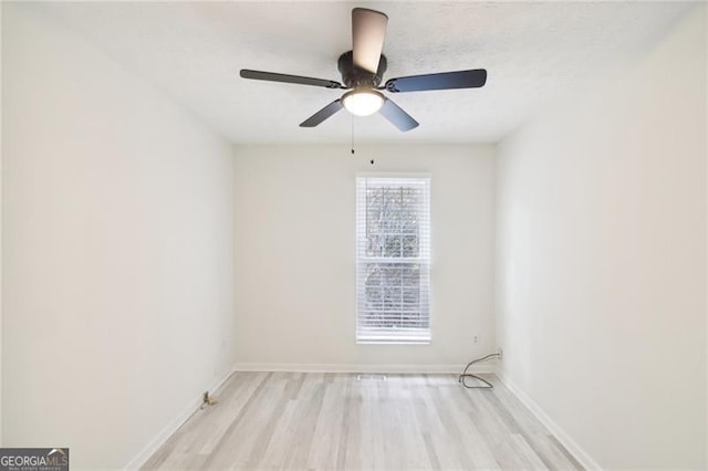 empty room with light wood-type flooring and ceiling fan