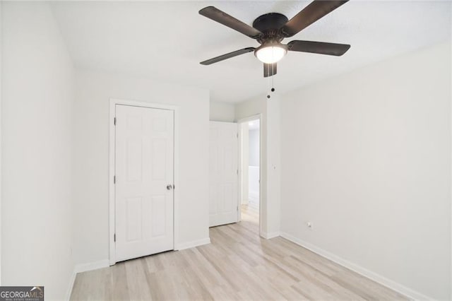 unfurnished bedroom with ceiling fan and light hardwood / wood-style floors