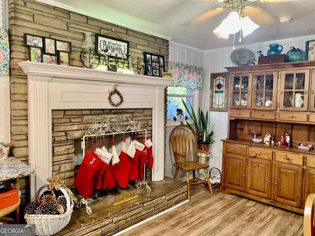 interior space with crown molding, ceiling fan, and light hardwood / wood-style floors