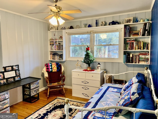 bedroom with ceiling fan, light hardwood / wood-style floors, and crown molding